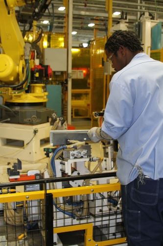 Photo of an employee working at the LMV Automotive Plant