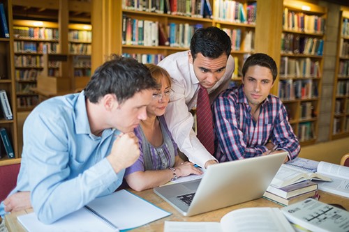 Photo of students sitting at a table studying
