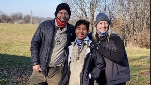 Photo of three individuals smiling