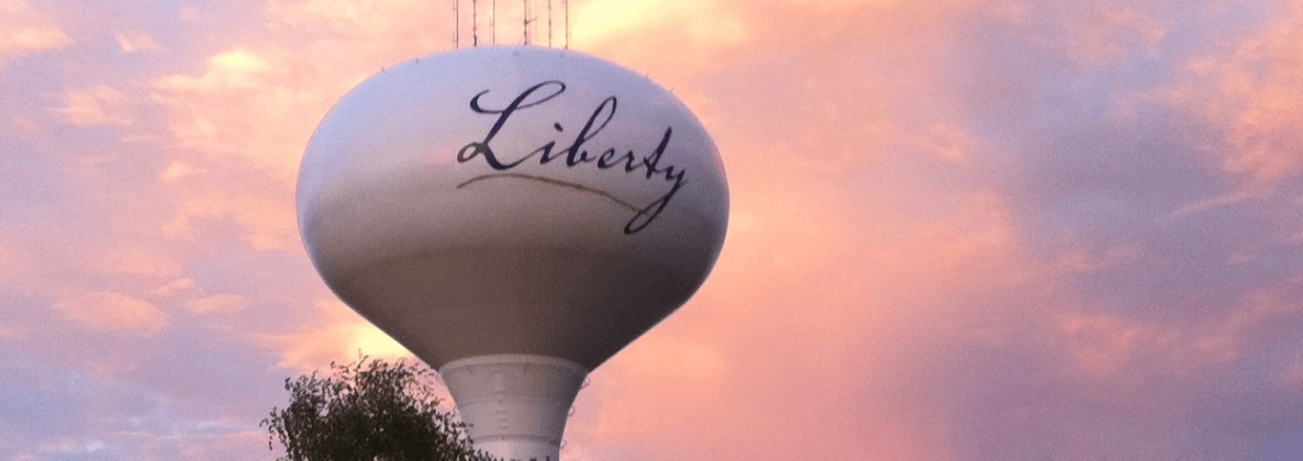 Photo of one of Liberty's Water Towers with a Sunset behind it