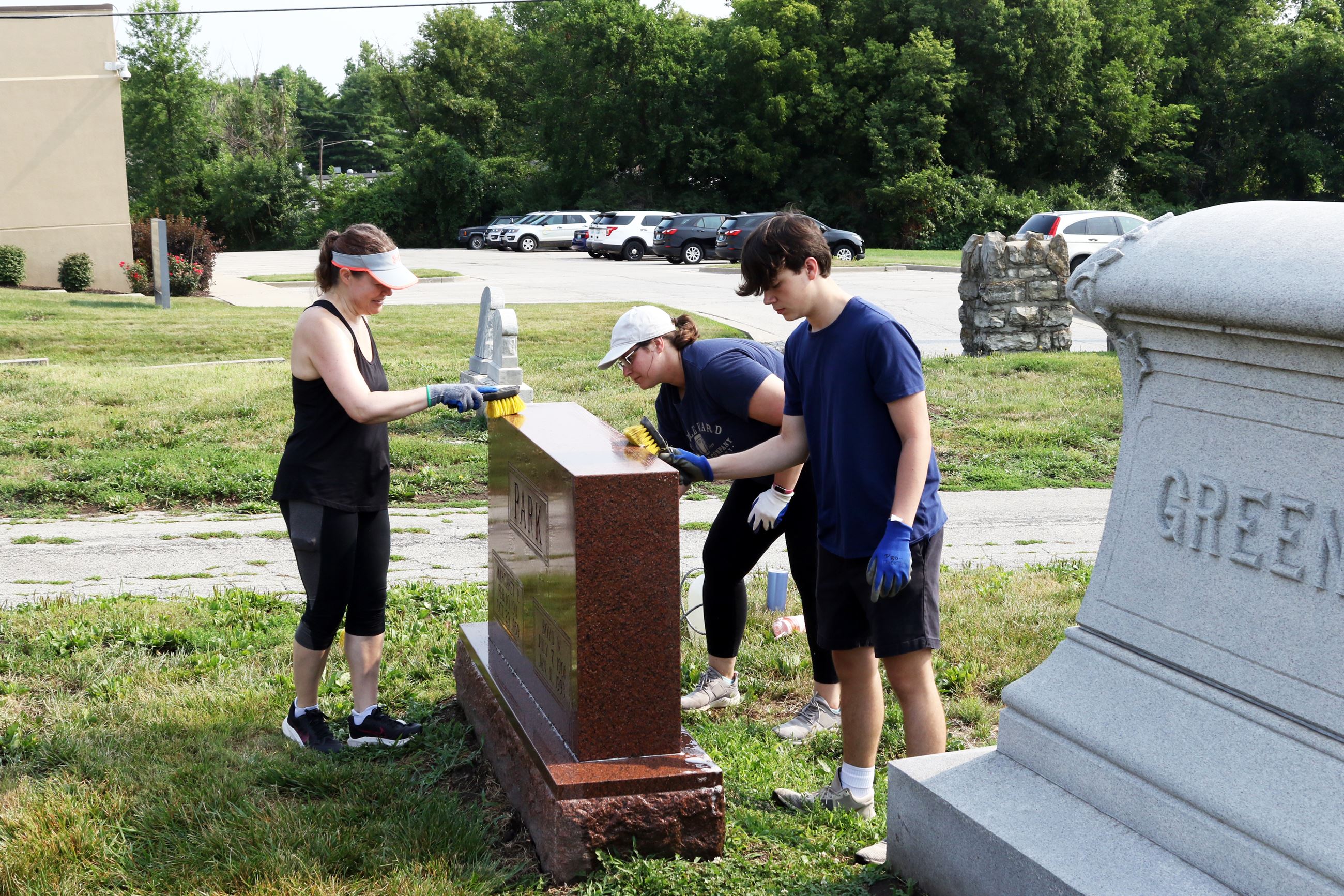 Volunteers Cleaning headstones at the Cemetery Work Day